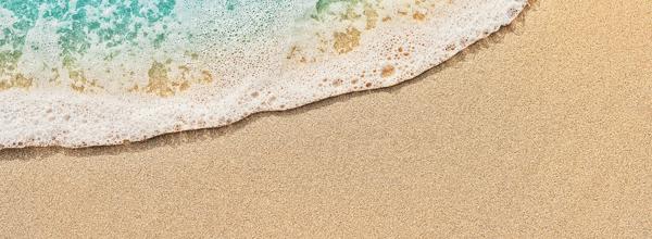 Top view of beach water meeting sand