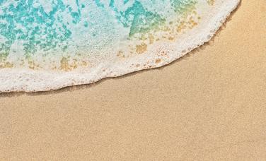 Top view of beach water meeting sand
